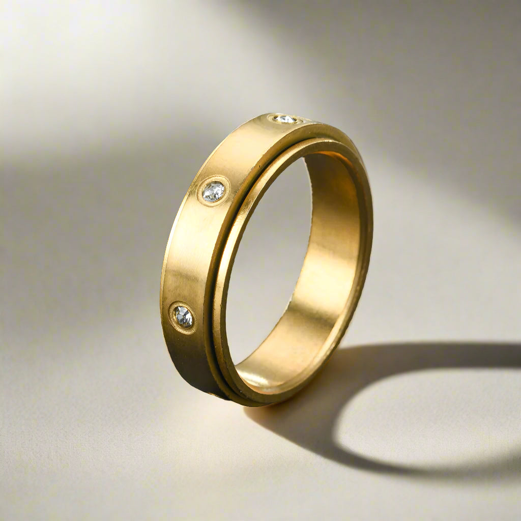 Gold ring with smooth surface and embedded gem stones